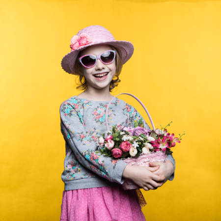 Little smile girl with flowers in basket.