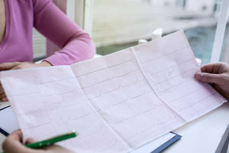 Closeup photo of ECG cardiogram pulse graph on a paper.の写真素材
