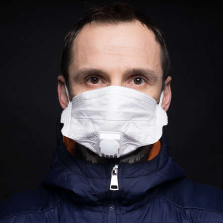 Man in mask . Protection against virus, infection, exhaust and industrial emissions.の写真素材