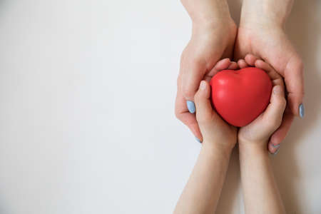 Heart in hands on light background. Healthcare background.の写真素材