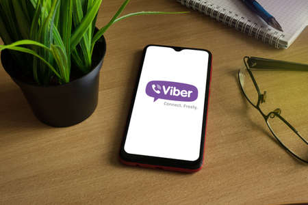 Minsk 12.05.2020. Smartphone on a wooden table with a image of Viber.