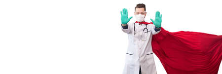 A doctor in a costume of a super hero stands on defense against a viral pandemicの写真素材