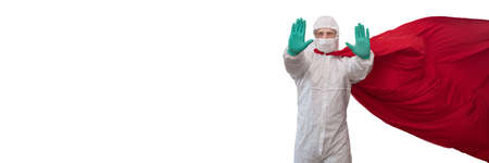 A doctor in a costume of a super hero stands on defense against a viral pandemicの写真素材