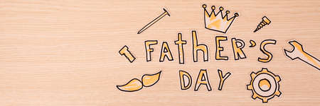 Paper inscription Father's Day with male paper objects on a yellow background.の写真素材