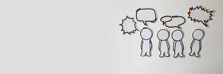 Paper figures with speech bubbles on the whiteの写真素材