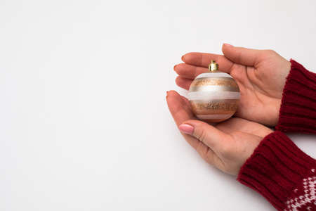 Woman hand with chrismas toy isolated on white
