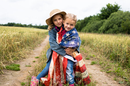 Little girls with american flag on the fieldの写真素材