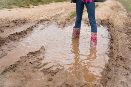 Girl run through the puddles and play.の写真素材