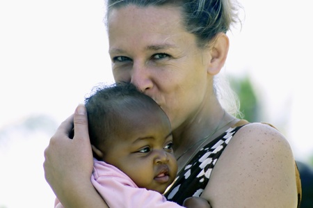 Beira,Mozambique-January 10,2010:Swiss woman,Barbara Hofmann,with a small child.Since 1989 after seeing the reality of war,it collects in its structure in Beira,children affected by war,orphaned and abandonedのeditorial素材