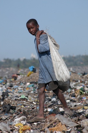 Maputo, Mozambique - May 14, 2004: a poor child in the landfill capital of Maputo in Mozambique. There are many street children in the garbage looking for food, bottles, Latin iron to resell                                のeditorial素材