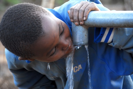 Mtito Andes, Kenya 13 JULY 2009:child drinking water from a source,thanks to various humanitarian organizations, the people of the village of Andes Mtito can fetch water from a source.のeditorial素材