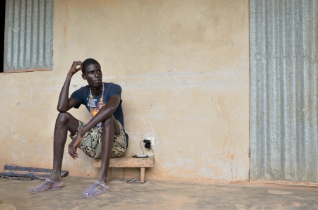 Kartiak,Senegal-September 18,2011:adolescent African and not identified sat in the terrace, of his...