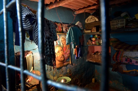 New Delhi,India-February 4, 2013:inside of a room with hung the figure of Jesus in the slum on February 4,2013 in New Delhi.The people of various religions pacifically cohabit, Christianity,Hinduism, Islam, Buddhism.のeditorial素材