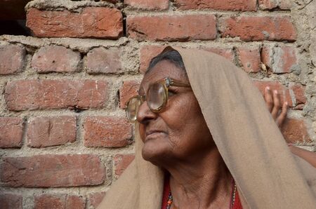New Delhi,India-February 4, 2013:Portrait of a elderly woman near his home located in the poor neighborhood of New Delhi のeditorial素材