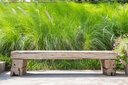 Wooden bench on green grass backgroundの写真素材