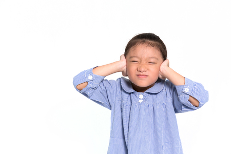Little asian girl angry and put hand closing her ears isolate on white backgroundの写真素材