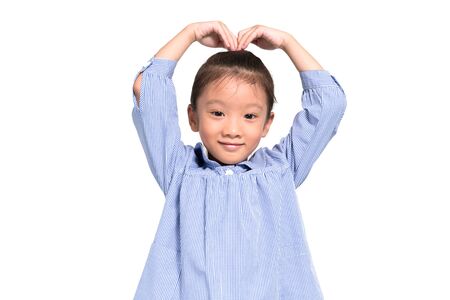 Little asian girl posing lovely and happy with isolate backgroundの写真素材