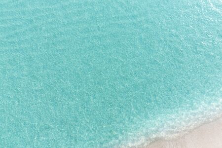 Close up blue sea water waves on white sand beach in Thailand, Beautiful blue sea beach with white sand, Beautiful blue ocean beach close up shot, Clean beach with blue sea in Thailandの写真素材