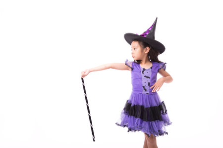 Little witch girl costume posing for halloween isolated on white background,Halloween costume girl posing isolated on white backgroundの写真素材