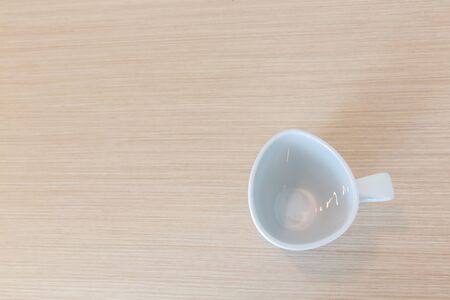 White cups on wooden bar table in bed room with blank space for text, top view photoの写真素材