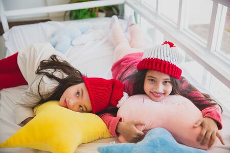 Little asia girl smiling  and enjoy playing on bed celebrate merry Christmas eveの写真素材