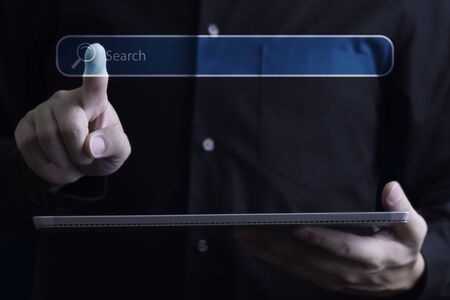 Businessman finger gesturing and searching data with digital tablet, Online smart technology conceptの写真素材