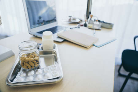 Medicine pill on table in doctor working room at hospital , Health care and medical concept wiht copy spaceの写真素材