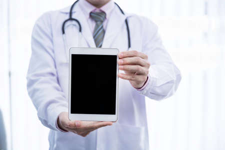 Man in virus protective suite and mask spraying alcohol cleaning covid19 infected area, Virus disinfection conceptの写真素材