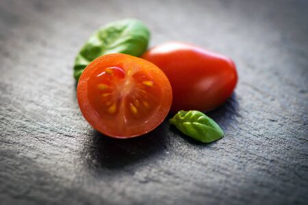 Cherry tomatoes and basil leavesの写真素材