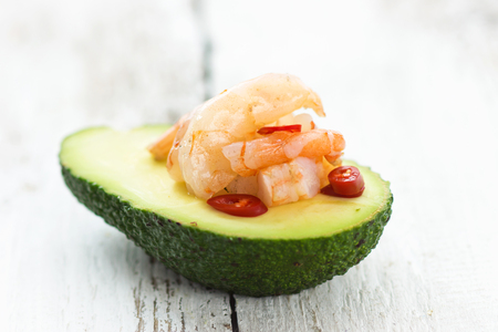 Avocado and prawns with chilli on a wooden backgroundの写真素材