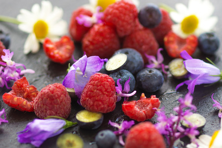 Fruit on a plate with flowersの写真素材