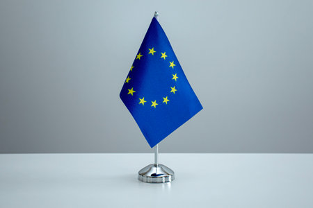 EU flag in a stand on tableの写真素材