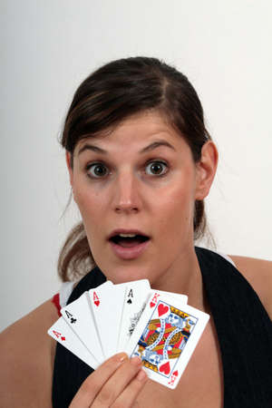 Playing Poker - beautiful young woman holding 4 aces and the king oh heart.のeditorial素材