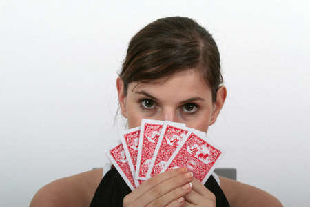 My Poker Cards. - a young beautiful woman is holding her poker cards.のeditorial素材