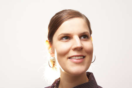 Woman Looking At Something - A young woman is looking into the corner of the image.