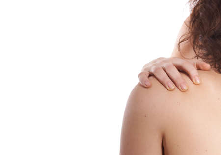 A young woman holds her back in pain! Isolated over white.の写真素材