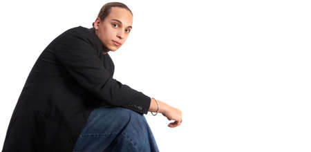 Young man with a suit and long hair is looking good.の写真素材