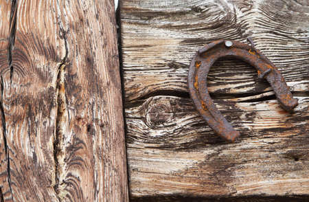 Horsehoe hanging on a piece of wood in the alps.の写真素材