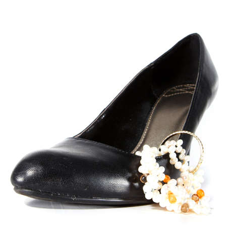 Black woman's shoe with jewelry. Isolated over white with lot's of copyspace!の写真素材