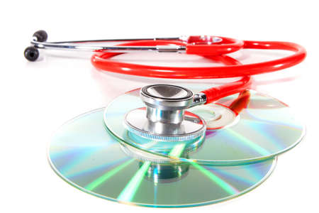 Stethoscope and a cd disk - checking the content of the disk. Could be used for medical and computer purposes!の写真素材