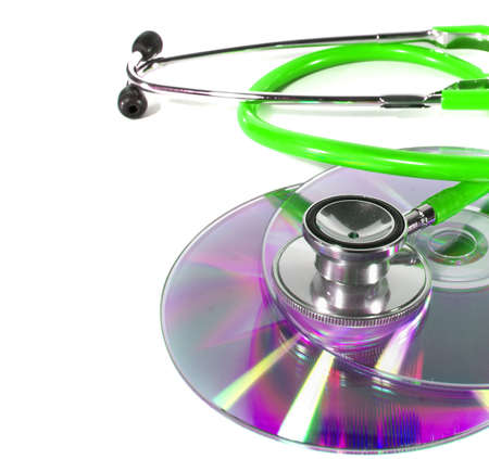 Green Stethoscope and a cd disk - checking the content of the disk. Could be used for medical and computer purposes! Highkey image!の写真素材