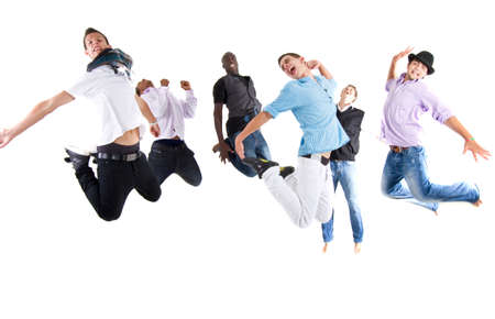 Group of six young stylish teenagers jumping in joy over white background.の写真素材