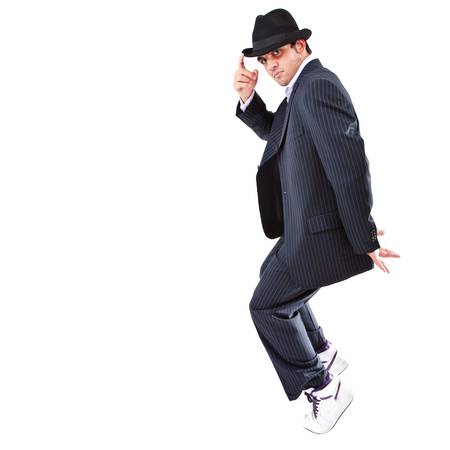 Young stylish teenager is showing dance moves Isolated over white background.の写真素材