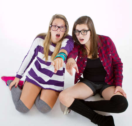 Young trendy teenagers in a nerd / geek style. Isolated over white background.