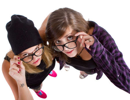 Young trendy teenagers in a nerd / geek style. Isolated over white background.の写真素材