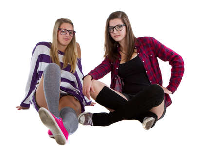 Young trendy teenagers in a nerd / geek style. Isolated over white background.の写真素材