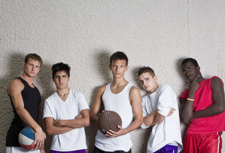 Young group of teenagers leaning against a wall. Stylish teens.の写真素材