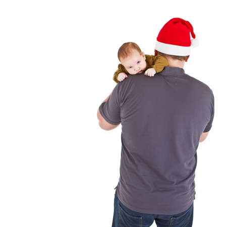 Father with chrismas hat is holding his baby daughter. Isolated over white.の写真素材
