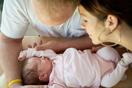 Young couple with their baby girl. Fresh happy family.の写真素材