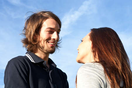 Young couple in love with blue sky in the background